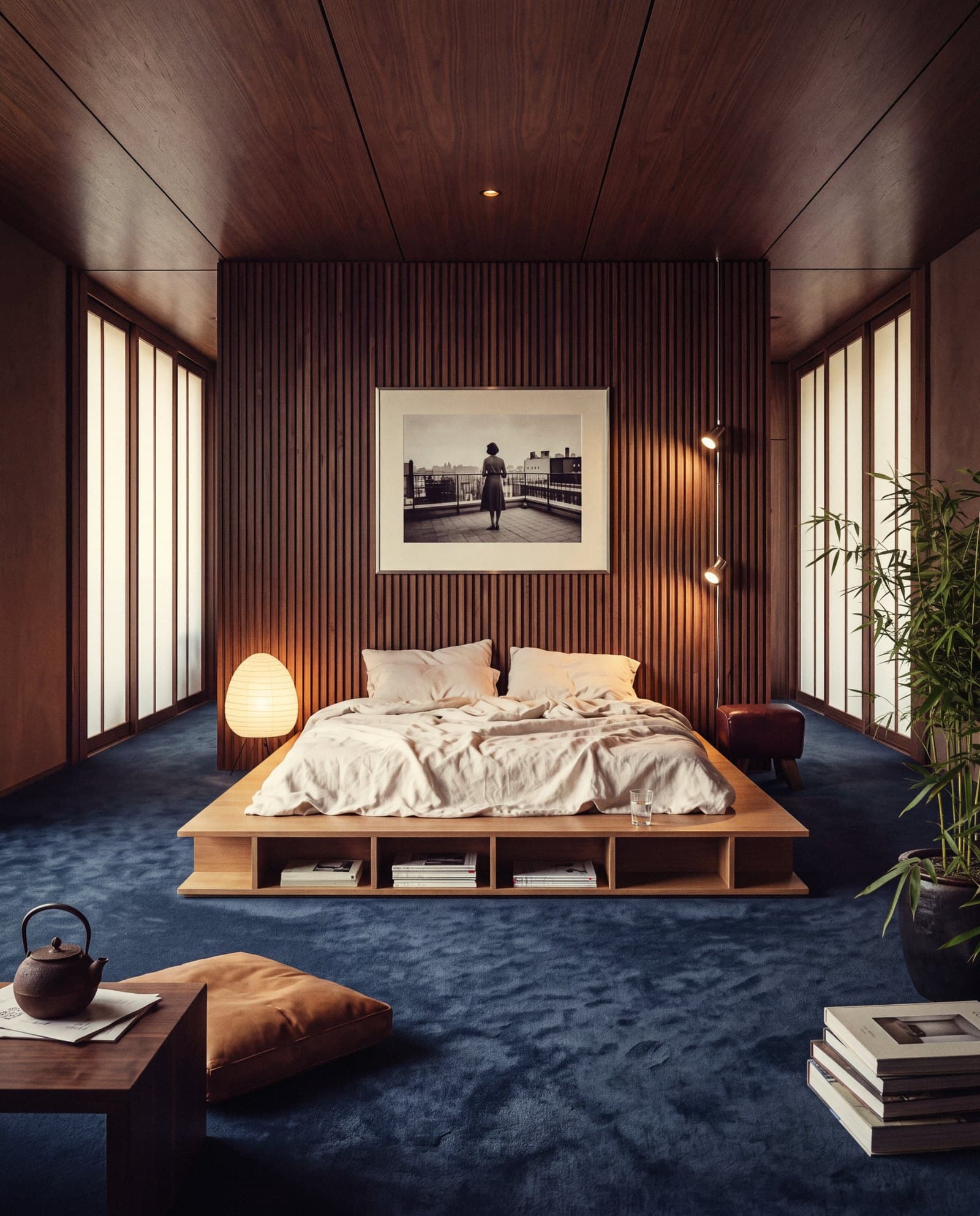 Bedroom with a fluted walnut wall, low oak platform bed, paper lantern and ink-blue carpet